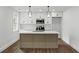 Modern kitchen featuring stainless steel appliances, stylish pendant lights and a kitchen island at 1111 Edgefield Sw Dr, Atlanta, GA 30310