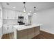 Modern kitchen with stylish pendant lighting, white cabinets, and stainless steel appliances at 1111 Edgefield Sw Dr, Atlanta, GA 30310