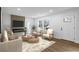 Bright living room with a modern fireplace and seating area and hardwood floors at 1111 Edgefield Sw Dr, Atlanta, GA 30310