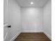 Small pantry with wood floor and white walls, offering storage space for kitchen supplies at 1111 Edgefield Sw Dr, Atlanta, GA 30310