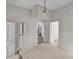 Bright bedroom features plank walls, vintage lighting, and doorways to additional rooms at 119 E Johnson St, Temple, GA 30179