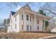 Elegant two-story home with white siding, a covered porch, and stately columns at 119 E Johnson St, Temple, GA 30179
