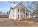 Exterior side view of the house with large front porch and pillared support, showcasing its classic design at 119 E Johnson St, Temple, GA 30179