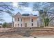 Classic two-story home featuring a white exterior with grand columns and a charming front porch at 119 E Johnson St, Temple, GA 30179