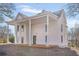 Two-story home featuring a white exterior, covered porch, and classic architectural details at 119 E Johnson St, Temple, GA 30179