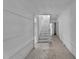 Bright hallway leading to staircase with natural light and classic white wood paneled walls at 119 E Johnson St, Temple, GA 30179