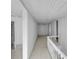 Hallway with stairs, white railings, beadboard walls, and doorways offer access to different parts of the house at 119 E Johnson St, Temple, GA 30179