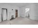 Living room with fireplace, plank walls, and doorways to the rest of the home at 119 E Johnson St, Temple, GA 30179