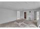 Bright living room featuring beadboard walls, fireplace, and natural light from the surrounding doorways at 119 E Johnson St, Temple, GA 30179