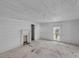 Room featuring a decorative fireplace, bright window, and doorway leading to another room at 119 E Johnson St, Temple, GA 30179
