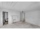 Open room featuring a brick fireplace, light fixture, and doorways leading to other rooms at 119 E Johnson St, Temple, GA 30179