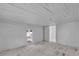 Bright room featuring beadboard walls and ceiling and an exterior door to the backyard at 119 E Johnson St, Temple, GA 30179