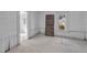 Bright room features a window and doorway to the outside and paneled walls at 119 E Johnson St, Temple, GA 30179