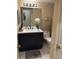 Modern bathroom with dark vanity, white countertops, white tile floors and modern fixtures at 1280 W Peachtree Nw St # 2201, Atlanta, GA 30309