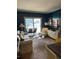 A well-lit living room featuring neutral tones, a comfortable sofa, balcony access, and modern decor at 1280 W Peachtree Nw St # 2201, Atlanta, GA 30309