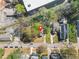 This aerial view shows the home in a densely populated suburban neighborhood with many trees at 240 Lamon Se Ave, Atlanta, GA 30316