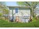 The backyard has a small basement door as well as chairs and a storage container at 240 Lamon Se Ave, Atlanta, GA 30316
