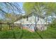 The backyard has a small basement door as well as chairs and a storage container at 240 Lamon Se Ave, Atlanta, GA 30316