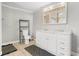 Well-lit bathroom with a double sink vanity and decorative rugs on a tiled floor at 240 Lamon Se Ave, Atlanta, GA 30316