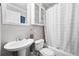 This bathroom features a shower/tub combo, a white vessel sink, and a white cabinet at 240 Lamon Se Ave, Atlanta, GA 30316