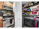 A combined laundry and utility area with stainless steel washer/dryer, overhead microwave, and storage shelves at 240 Lamon Se Ave, Atlanta, GA 30316
