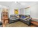 Cozy living room features a gray leather sectional, patterned rug, and natural light from the window at 240 Lamon Se Ave, Atlanta, GA 30316