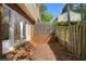Fenced backyard with a brick garden, tree, and a grassy area perfect for outdoor activities at 3326 Northcrest Rd # C, Atlanta, GA 30340