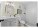 Modern bathroom showcases a walk-in shower, a gray vanity with a round mirror, and stylish fixtures for a luxurious feel at 3326 Northcrest Rd # C, Atlanta, GA 30340