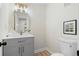 Contemporary bathroom features a round mirror, gray vanity, and a modern toilet for a clean, stylish look at 3326 Northcrest Rd # C, Atlanta, GA 30340