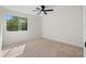 Empty bedroom featuring neutral walls, carpet, ceiling fan, and natural light from the large window at 3326 Northcrest Rd # C, Atlanta, GA 30340