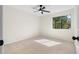 Empty bedroom featuring neutral walls, carpet, ceiling fan, and natural light from the large window at 3326 Northcrest Rd # C, Atlanta, GA 30340