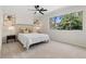 Bright bedroom featuring neutral walls, carpet, ceiling fan, and natural light from the large window at 3326 Northcrest Rd # C, Atlanta, GA 30340