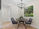Cozy dining area features a round table and seating for four, complemented by a modern chandelier and natural lighting at 3326 Northcrest Rd # C, Atlanta, GA 30340