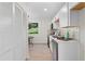Modern kitchen featuring bright cabinets, stainless steel appliances, quartz counters, and ample storage space at 3326 Northcrest Rd # C, Atlanta, GA 30340