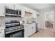 Bright kitchen with stainless appliances, light cabinets, and gold hardware that creates a stylish, functional cooking space at 3326 Northcrest Rd # C, Atlanta, GA 30340