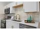 Bright kitchen with stainless appliances, light cabinets, and gold hardware that creates a stylish, functional cooking space at 3326 Northcrest Rd # C, Atlanta, GA 30340
