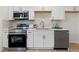 A modern kitchen boasts stainless steel appliances, white cabinets, and a quartz countertop for a sleek and efficient space at 3326 Northcrest Rd # C, Atlanta, GA 30340
