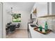 Well-lit kitchen with stainless steel appliances, white cabinets, and a dining area with seating by the window at 3326 Northcrest Rd # C, Atlanta, GA 30340