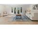 Bright living room with hardwood floors and French doors leading to the backyard at 3326 Northcrest Rd # C, Atlanta, GA 30340