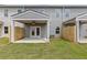 Cozy backyard with a covered patio, fan, fenced yard, and well-maintained lawn at 877 Pensive Run, Dacula, GA 30019
