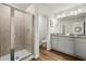 Bright bathroom with double vanity, granite countertop, and a glass enclosed shower at 877 Pensive Run, Dacula, GA 30019