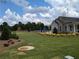 Community building surrounded by manicured lawn, playground, and trees at 877 Pensive Run, Dacula, GA 30019