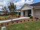 Community building exterior with manicured landscaping, sidewalk, and nearby trees at 877 Pensive Run, Dacula, GA 30019