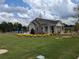 A charming community building featuring a pool, lounge chairs, and lush landscaping at 877 Pensive Run, Dacula, GA 30019