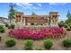 Alcovey Meadows entrance featuring a stone and wooden sign surrounded by colorful flowers at 877 Pensive Run, Dacula, GA 30019