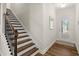 Bright entryway featuring wood-look floors, staircase and a front door with window, complemented by neutral wall colors at 877 Pensive Run, Dacula, GA 30019