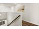 Bright hallway with stairs, wood floors, and stylish decor at 877 Pensive Run, Dacula, GA 30019