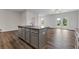 Bright kitchen with stainless steel appliances, granite countertops, and a center island overlooking the living space at 877 Pensive Run, Dacula, GA 30019