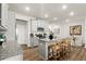 The Kitchen has gray cabinets, stainless appliances, a large granite island, and hardwood floors and a dining area at 877 Pensive Run, Dacula, GA 30019