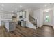 Modern kitchen with gray cabinets, stainless steel appliances, a center island, and laminate flooring at 877 Pensive Run, Dacula, GA 30019